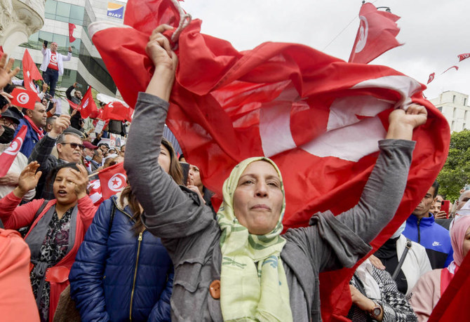 Tunisian demonstrators chant slogans and wave their country’s national flag in support of President Kais Saied in Tunis. (AFP)