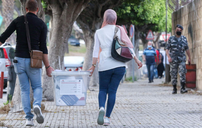 Lebanese civil servants receive sealed ballot boxes at the governmental saray in Sidon on May 14, 2022. (AFP)