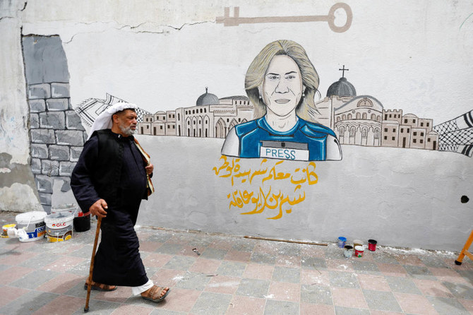 A man walks past a mural of Shireen Abu Akleh in the southern Gaza Strip. (Reuters)