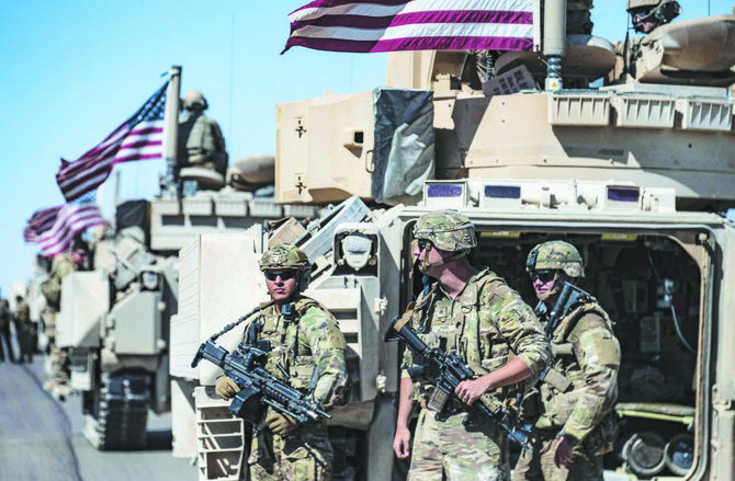 American forces patrol near the countryside of Rumaylan in Syria’s northeastern Hasakeh province near the border with Turkey. 