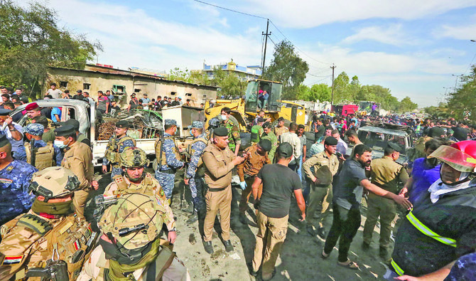 Members of the Iraqi army and security forces gather at the scene of a deadly explosion carried out by Daesh