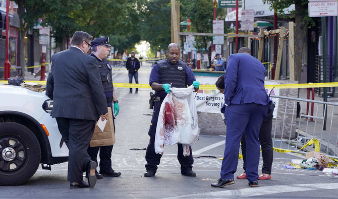 Philadelphia Police investigators work the scene of a fatal overnight shooting on South Street in Philadelphia