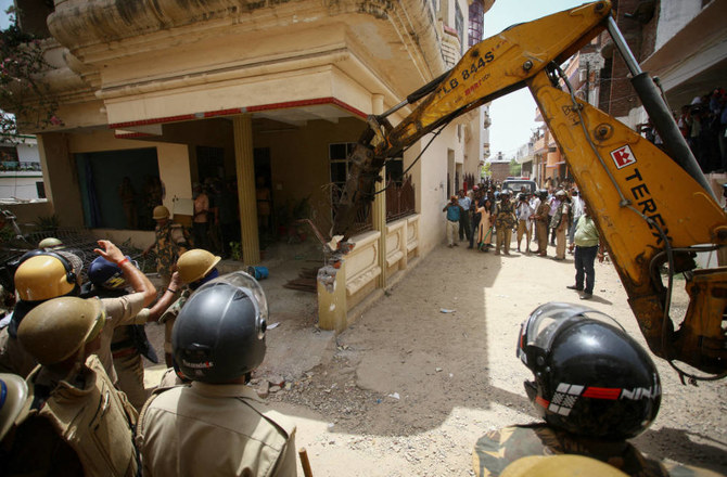 Heavy equipment is used to demolish the house of a Muslim man in Prayagraj, India, June 12, 2022. (REUTERS)