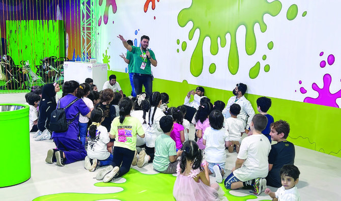 The venue features a giant slime station, where two leaders direct two groups of 20 children to make giant slime bubbles