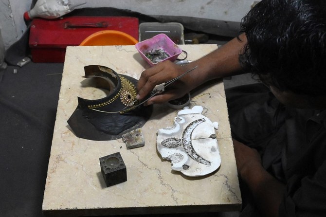 At Lahore’s famed Rang Mahal bazaar, scavengers sift through dirt for gold
