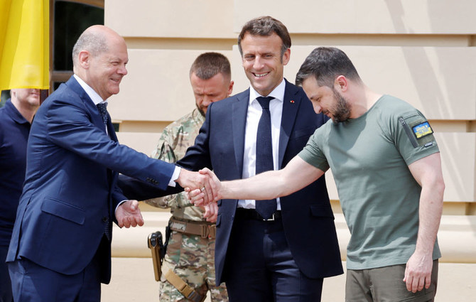 Ukrainian President Volodymyr Zelensky (R) shakes hands with Germany's Chancellor Olaf Scholz (L) next to France's Macron. (AFP)