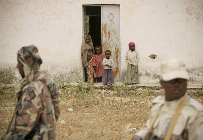 Children look on as Somali security personnel patrol in the Middle Shabelle region, Mogadishu. (REUTERS)