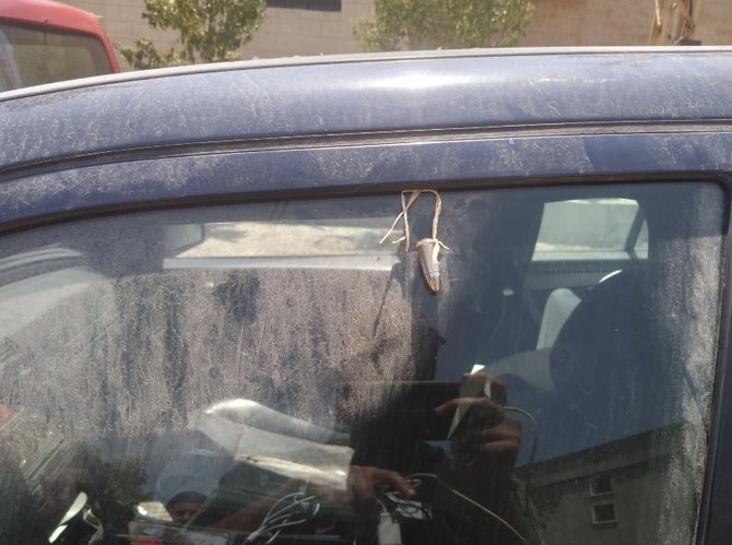 Hezbollah loyalists attack Lebanese photojournalist, leave bullet on his car
