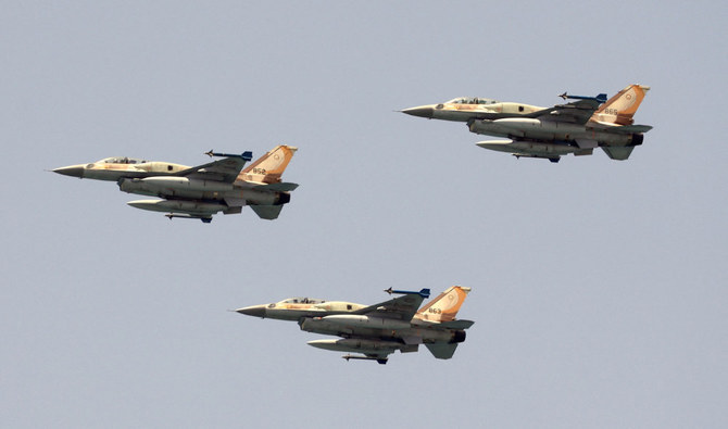 Israeli F-16 fighter jets perform during an air show over the beach in the Israeli coastal city of Tel Aviv on May 5, 2022. (AFP