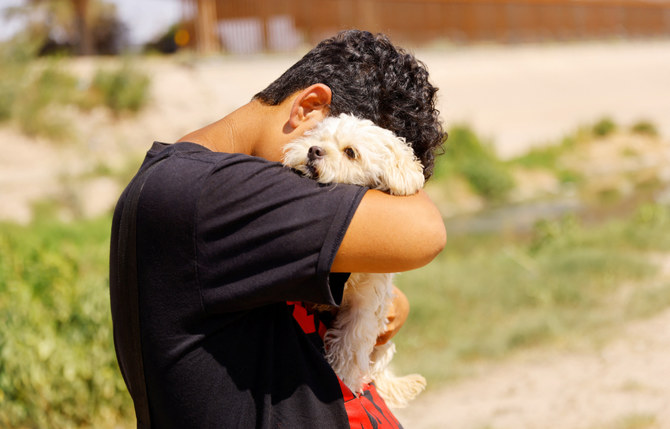 Brayan Pinto, a migrant from Venezuela seeking asylum, says goodbye to his dog Brandy. (REUTERS)