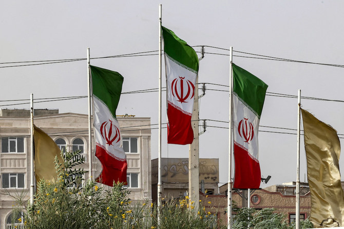 The flags of Iran flutter during a sandstorm in the south of the capital Tehran on July 4, 2022. (AFP)