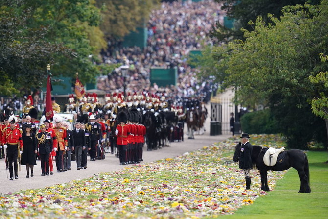 Mourners lining streets for Queen Elizabeth’s funeral share thoughts about her and future of the monarchy