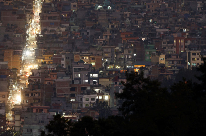 Light illuminates a street between the cluster of residential buildings in Kathmandu, Nepal November 8, 2022. (REUTERS)