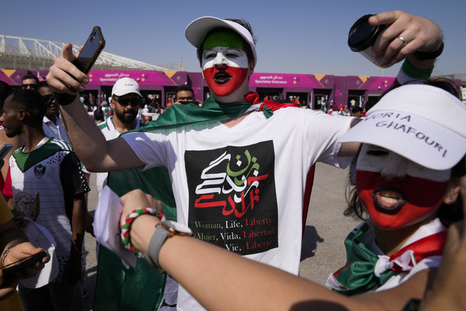 Iran government supporters confront protesters at World Cup