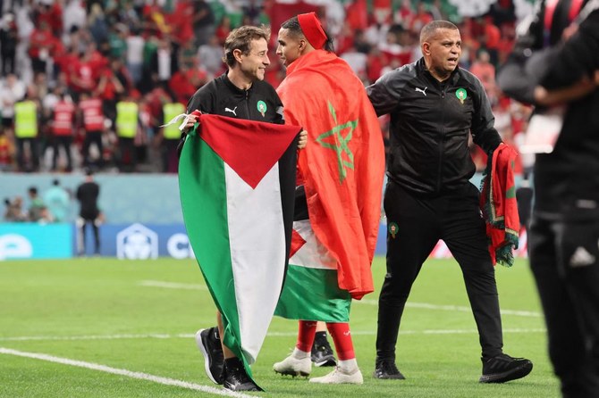 Morocco players celebrate with Palestinian flag after Spain upset