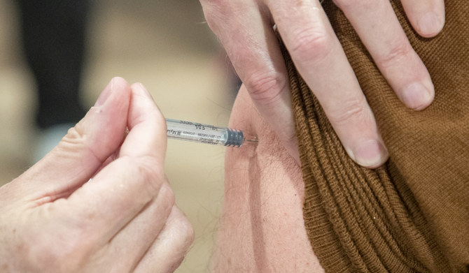 A patient receives a dose of vaccine during a vaccination campaign against the flu. (AFP)
