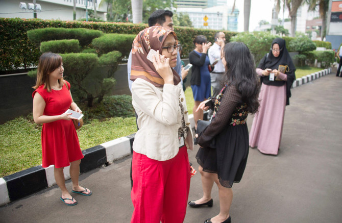 Indonesians stand outside their office buildings after a 6.4 magnitude quake hit Jakarta. (AFP file photo)