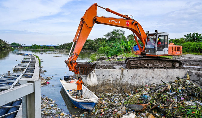 Workers clearing mounds of floating plastic waste of the Klang river, in Klang, on the outskirts of Kuala Lumpur. (AFP)