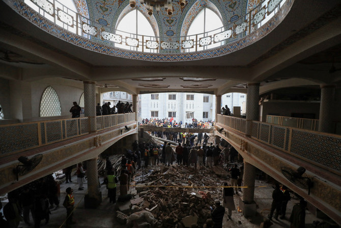People look for survivors under a collapsed roof, after a suicide blast in a mosque in Peshawar on January 30, 2023. (Reuters)