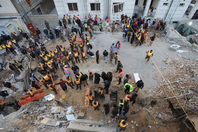 Rescue workers look for survivors under a collapsed roof, after a suicide blast in a mosque in Peshawar, Pakistan. (Reuters)