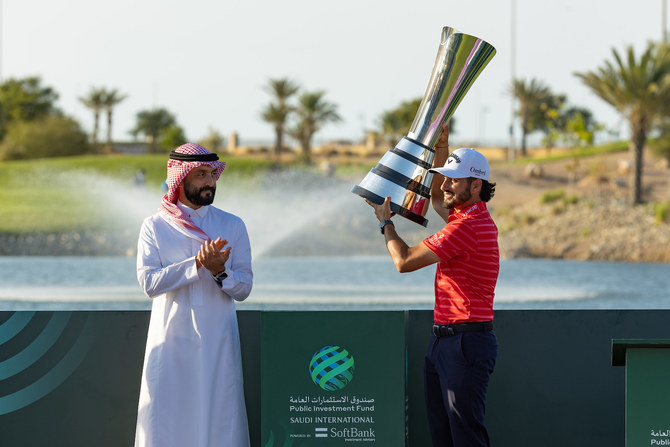 Golf Saudi CEO Noah Alireza hands Abraham Ancer the trophy. (Golf Saudi) 