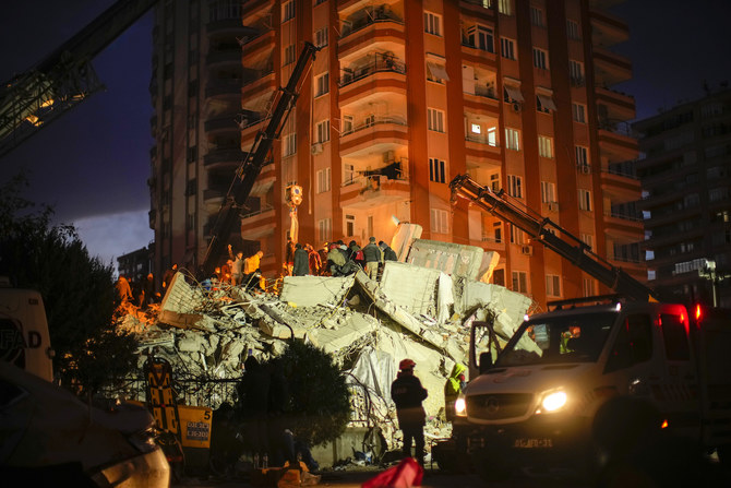 Emergency team members search for people in a destroyed building in Adana, Turkey, Tuesday, Feb. 7, 2023. (AP)