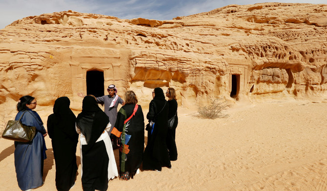 Visitors tour at majestic rock-hewn tombs of Madain Saleh near the city al-Ula, Saudi Arabia. (REUTERS)
