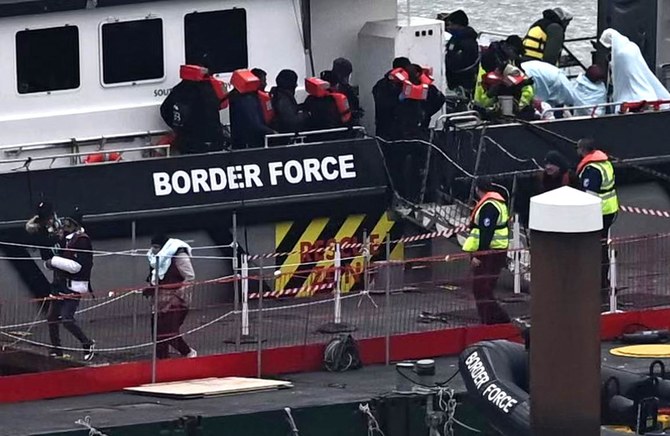 Migrants are escorted ashore from the UK Border Force vessel ‘BF Ranger’ in Dover, southeast England, on March 6, 2023.