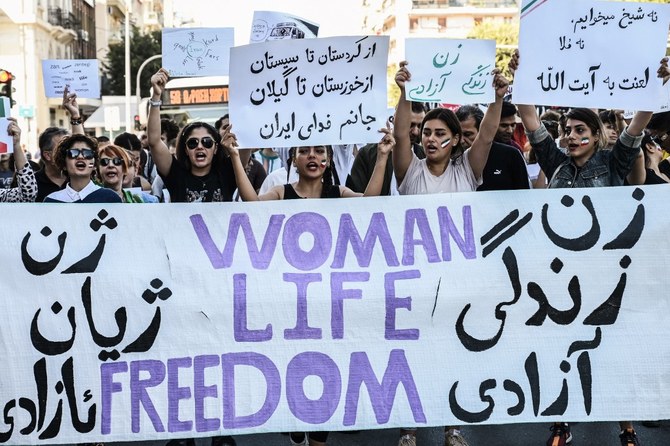Iranians living in Greece chant slogans and hold placards during a demonstration, following the death in Tehran of Mahsa Amini. 