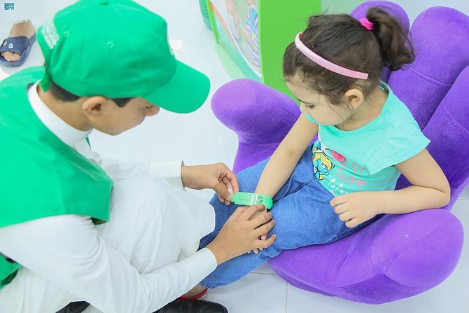 Children given wristbands at Two Holy Mosques 