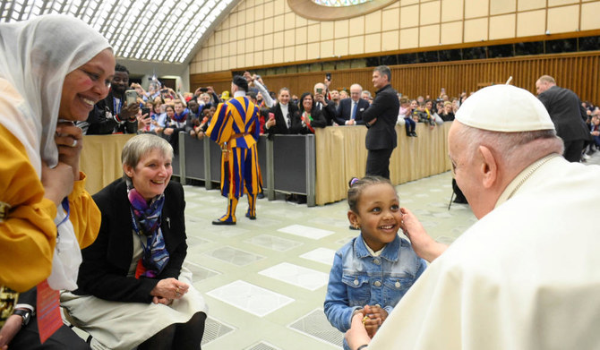 Pope Francis attends a meeting with refugee families at the Paul VI Hall at the Vatican, March 18, 2023. (REUTERS)