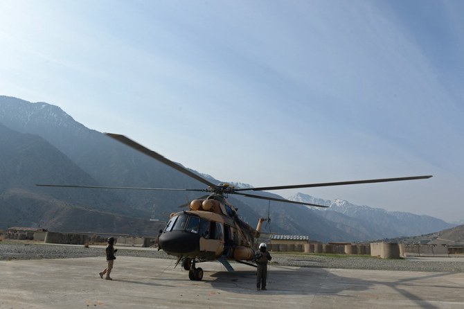 An Afghan pilot walks near a military helicopter in Kunar province. (File/AFP)