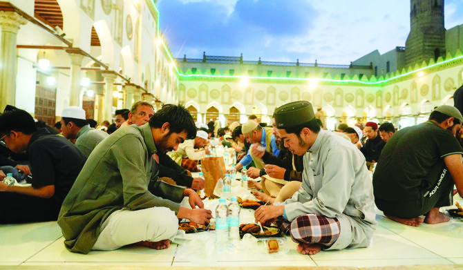 Muslims breaking their fast at a free public iftar in Al-Azhar Mosque in Cairo. (AP)