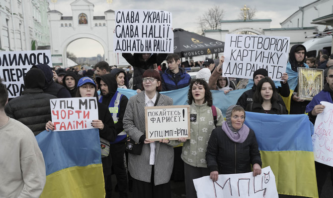 Protesters face off in Kyiv as clergyman’s home raided