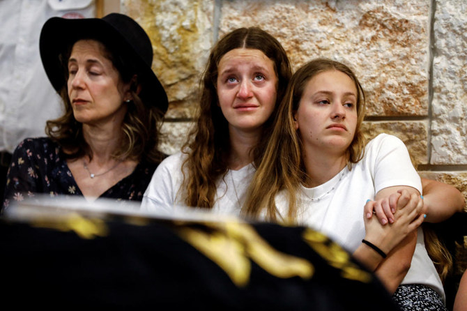 Sisters of Maia and Rina Dee, Israeli-British sisters killed in a shooting attack, mourn during their funerals.