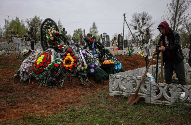 ‘Unbridled grief’: Ukrainian woman buries toddler son, husband after strike