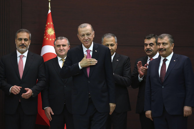 Turkish President Recep Tayyip Erdogan stands with the new cabinet members during the inauguration ceremony in Ankara. 