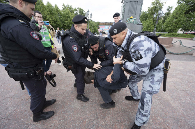 Police officers detain a demonstrator in Pushkinskaya Square in Moscow, Russia, Sunday, June 4, 2023. (AP)