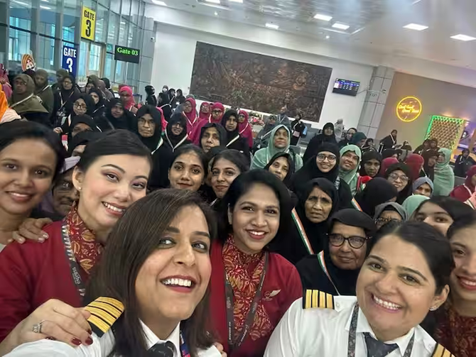 Pilots, crew members and passengers of a women-only Hajj flight pose for a photo before departing from Kozhikode on June 8.