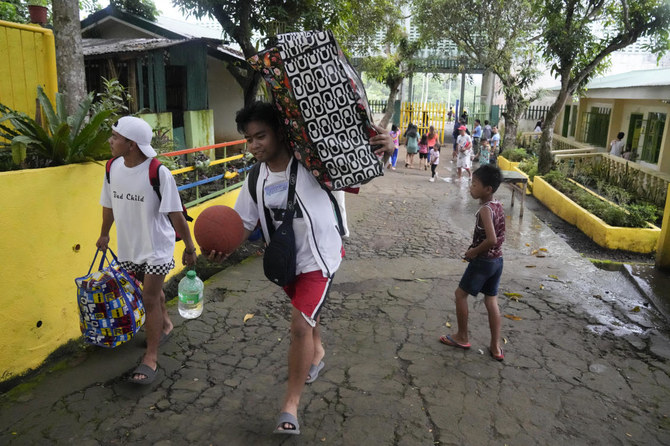Rains unleashed by typhoon worry thousands of people fleeing restive Philippine volcano