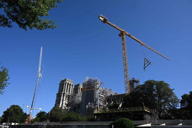 Crane at fire-ravaged Notre Dame in Paris hoists giant wood trusses to the cathedral’s roof
