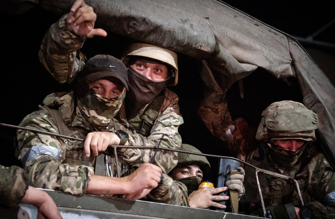 Members of Wagner group looks from a military vehicle in Rostov-on-Don late on June 24, 2023. (AFP)