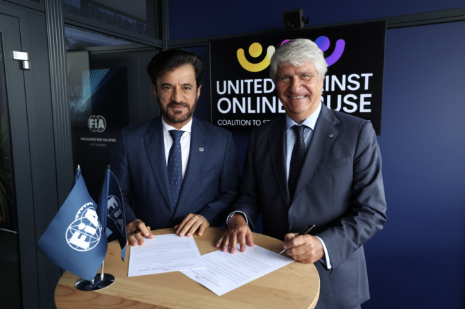 FIA President Mohammed Ben Sulayem and FIM President Jorge Viegas sign a charter to counter online abuse in sport. (Supplied)