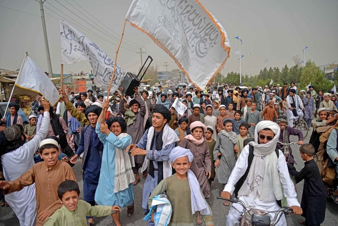 Taliban supporters march during a rally to celebrate the second anniversary of Taliban’s takeover in Kandahar, Afghanistan.