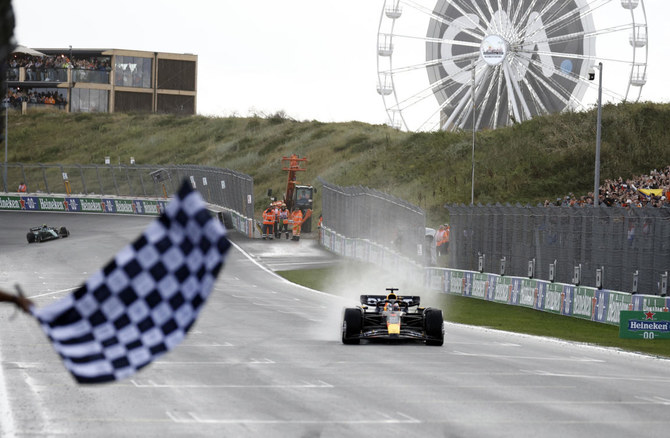 Red Bull’s Max Verstappen passes the chequered flag to win the Dutch Grand Prix. (Reuters)