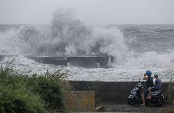 People watch huge waves in Yilan as Typhoon Haikui makes landfall in eastern Taiwan on September 3, 2023. (AFP)