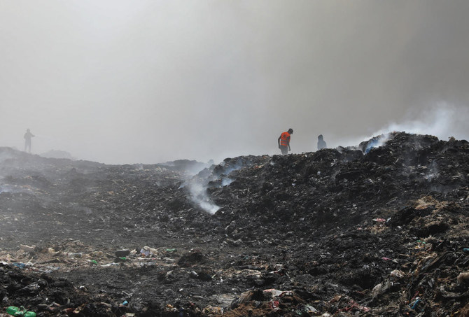 A Palestinian extinguishes a fire at a landfill in Juhr al-Deek, southeast of Gaza City, September 3, 2023. (Reuters)