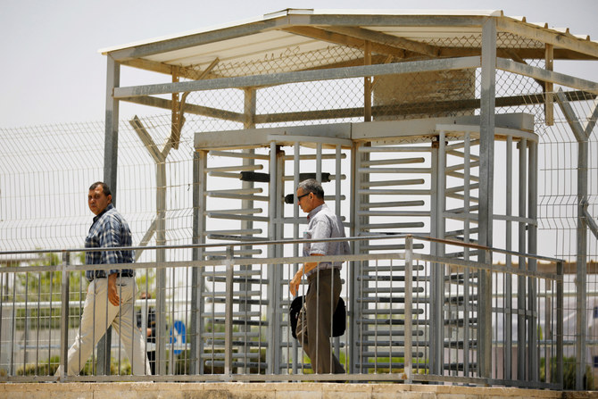 Palestinian men walk through a turnstile on the Israeli side of Erez crossing, on the border with Gaza June 23, 2019. (REUTERS)