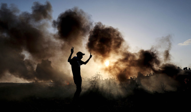   Palestinian demonstrators burn tyres during clashes with Israeli soldiers along the Israel-Gaza border on September 15, 2023. 