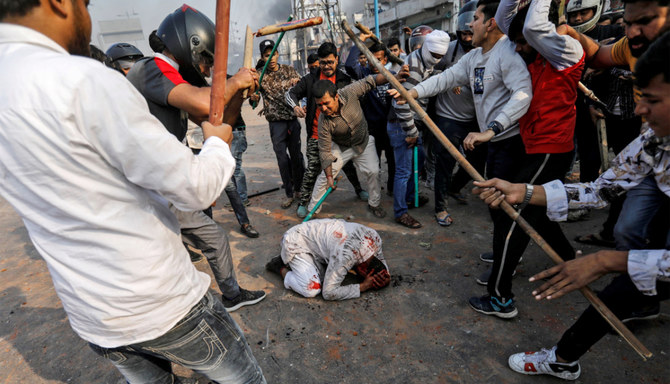 RSS Hindutva supporters beat a Muslim man during a clash in New Delhi, India, February 24, 2020. (REUTERS)